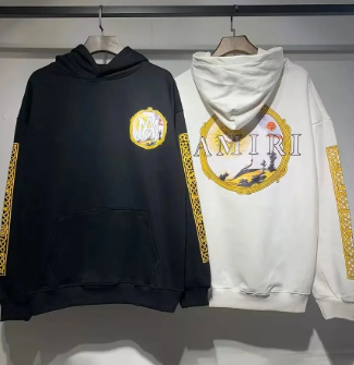Black and white pullover hoodies hanging side by side
