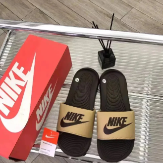 Brown and tan slide sandals with shoebox